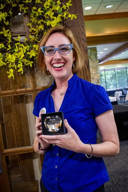 Beth Daniel Lindsay of Wabash College holds the Heart of PALNI Award and smiles