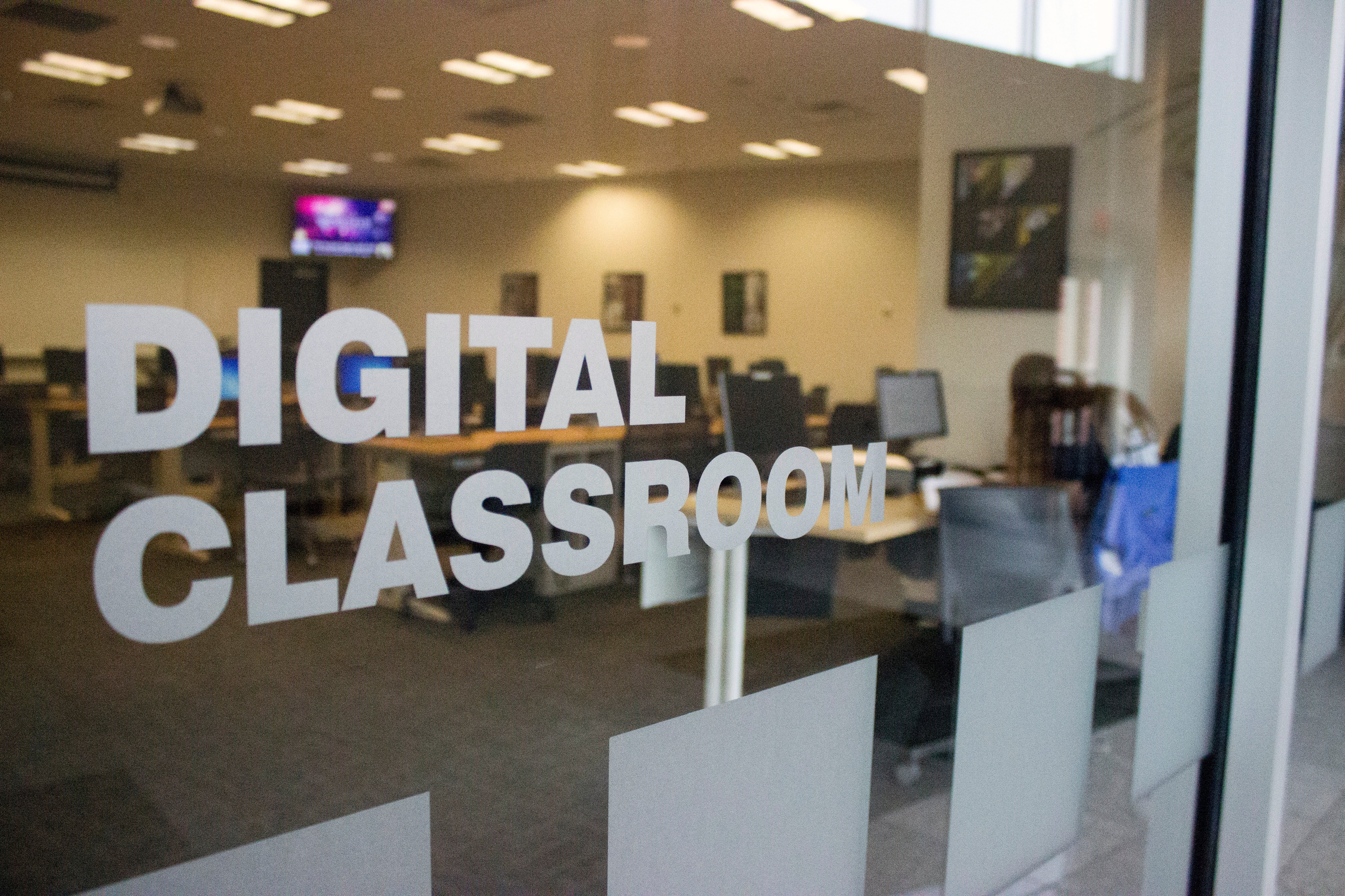 Outside of a Digital classroom at Trine University looking in at computer stations