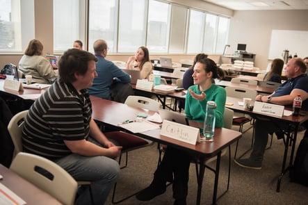 Group of individuals sitting across from each other and having a conversation