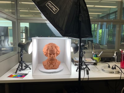 Bust of Mark Twain inside photogrammetry box with lights surrounding it