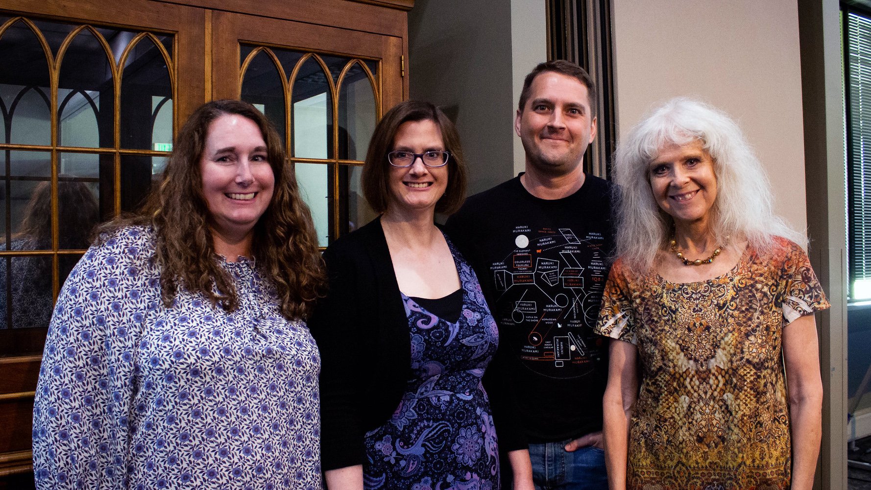 Manchester University library staff members standing and smiling