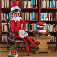 Toy elf sitting in a chair with legs crossed next to a bookshelf and piles of toy books on a table.