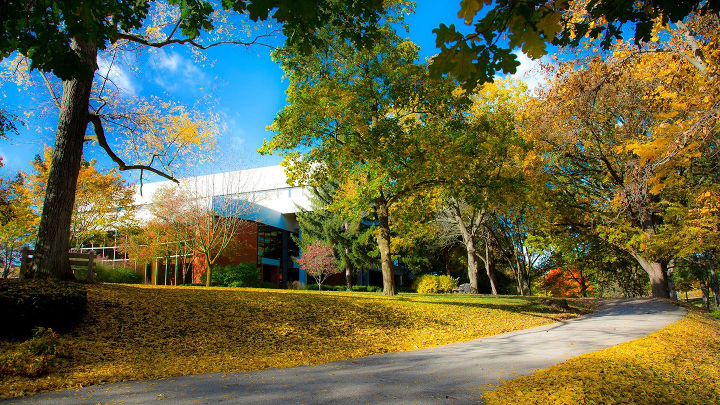 Anderson University outdoor shot of campus with large white building and colorful trees.