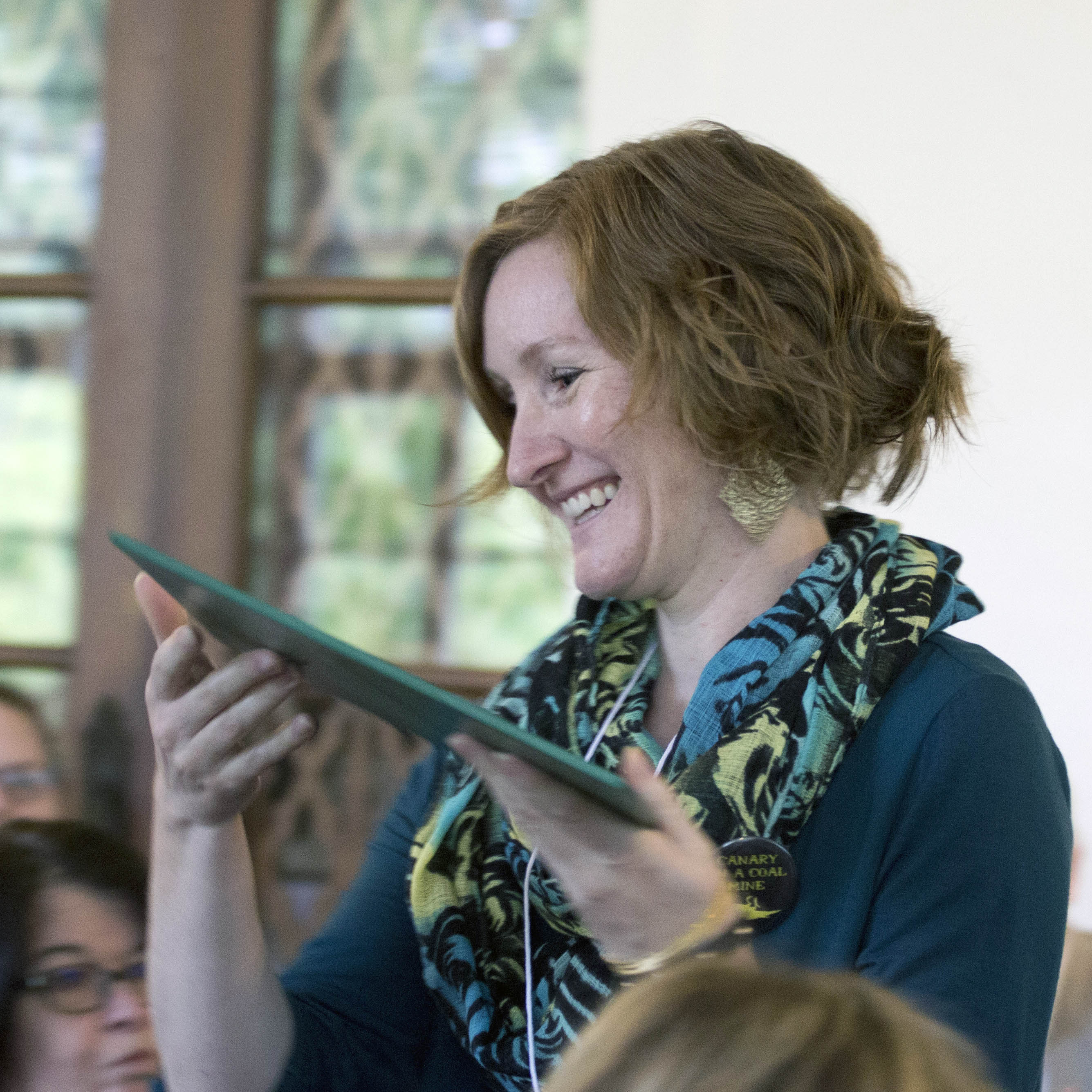 Person holding award certificate and smiling