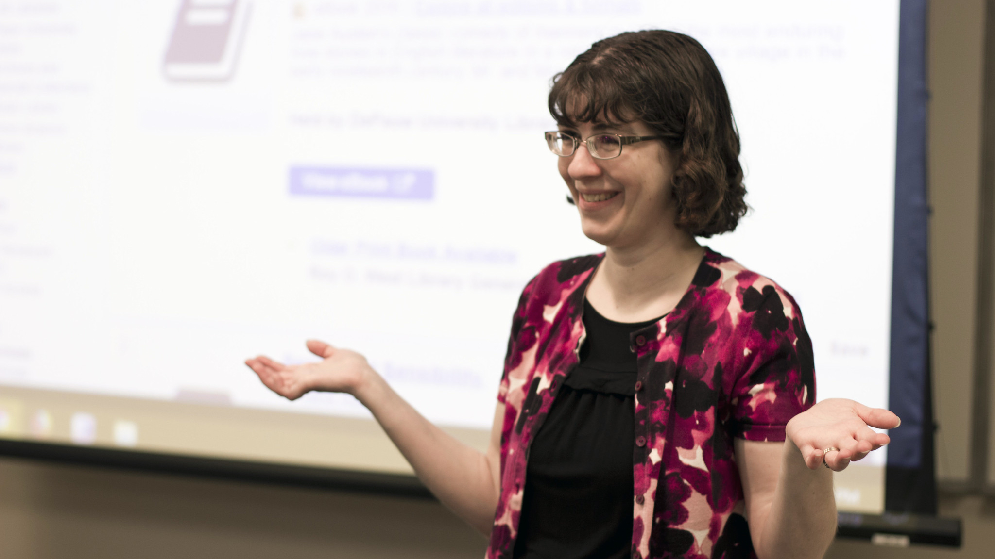 PALNI coordinator and consultant Ruth Szpunar standing in front of screen and smiling