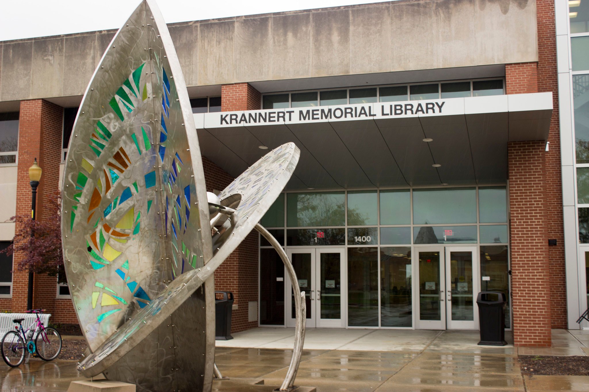 Front facade of Krannert Memorial Library with decorative statue in foreground